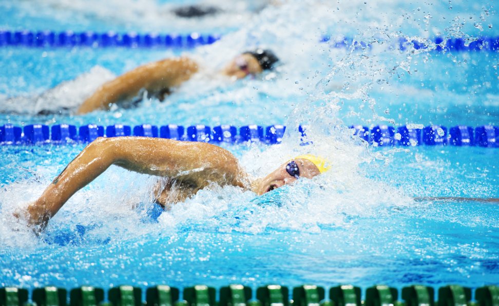 Swimmers competing in a swimming pool.